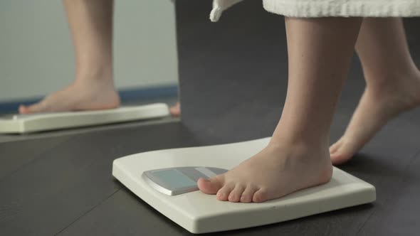 Normal Weight, Girl Checking Dieting Results on Scales at Home, Healthy Body alt