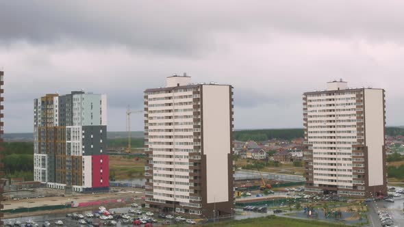 Timelapse with Dynamic Zoom Effect a Sleeping Area with Apartment Complexes and Onestory Houses Over alt