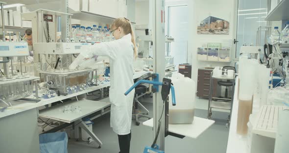 Scientist working in a pharmaceutical laboratory conducting experiments alt