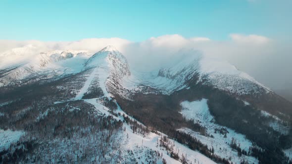 Rysy Peak in High Tatras National Park. Drone flying high over snowy mountain alt