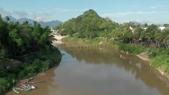 Aerial view of wooden bridge on Namkhan river in Luang Prabang, Laos alt
