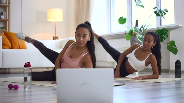 Online Fitness Workout By Mixed Race Sisters Watching Video alt