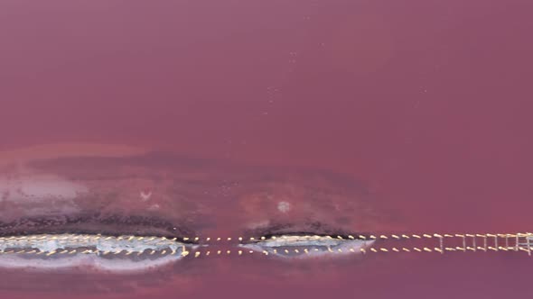 Aerial Shot of a Sand Spit Surrounded with Dark Pink Waters in the Black Sea 