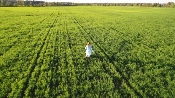 Girl Running On Sunlight Field