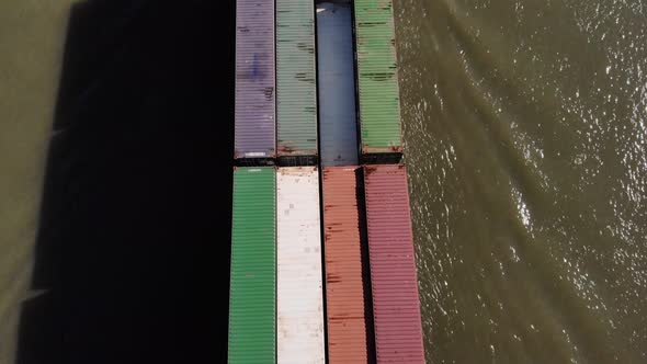 Cargo Ship Loaded With Bulk Of Shipping Containers Sailing At Oude Maas River In Netherlands. - aeri alt