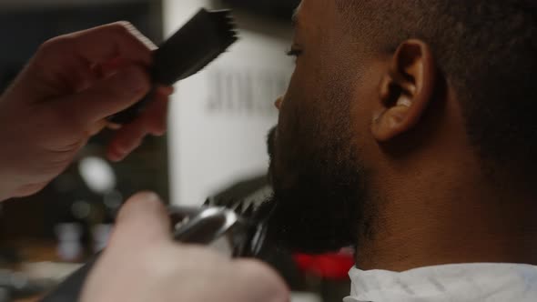 Fashionable Darkskinned Guy Gets a Beautiful Beard Hairstyle in a Barbershop