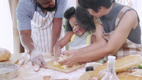 Close up of Happy African American family helping for make dough together for cookie alt