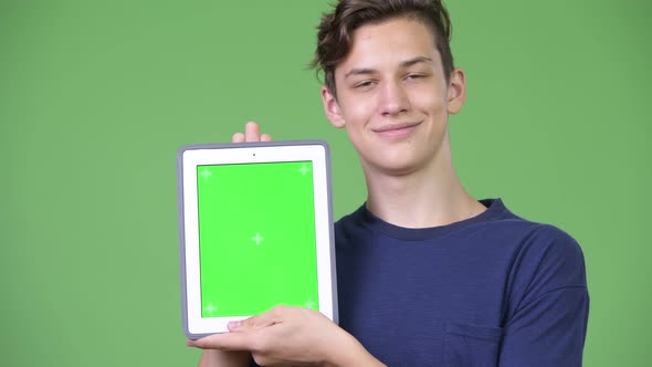 Young Handsome Teenage Boy Showing Digital Tablet alt