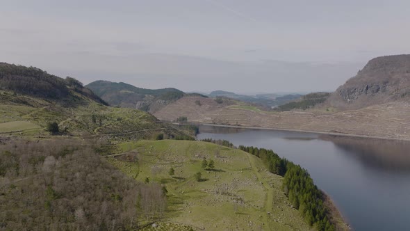 Aerial drone push in over Norway, farm and lake. West Coast. alt