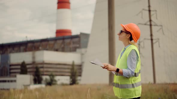 Power Station Electrical Energy High Voltage. Electricity Worker On High Voltage Tower. alt