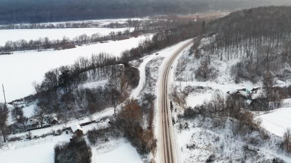 A Long Road Over the Road Through a Snowcovered Village in the Surrounding Area alt