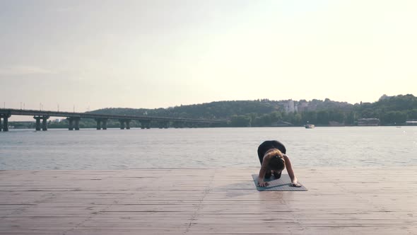 Girl Doing Yoga on the Pier