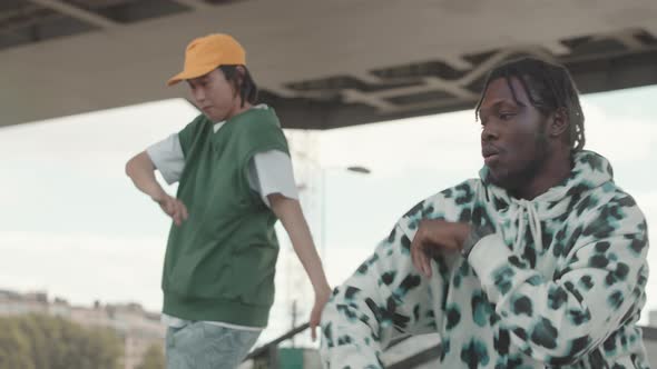 Two Multiethnic Freestyle Dancers Dancing at Construction Site alt