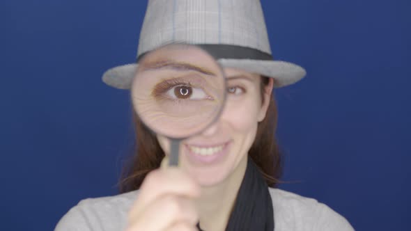 Funny Girl Looking Throw Magnifier To the Camera  alt