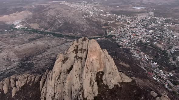 Pena de Bernal Towering Above Pueblo Magico Town Of San Sebastian Bernal In Queretaro, Mexico. Aeria alt
