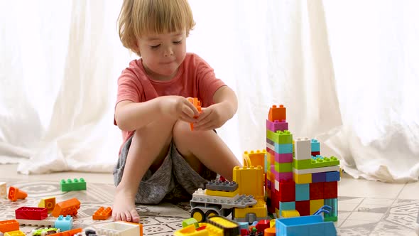 Little Boy Builds Colored Blocks alt