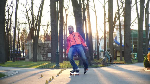 Training of a Professional Roller Who Skillfully Skates in the Central Park of the City and Performs alt