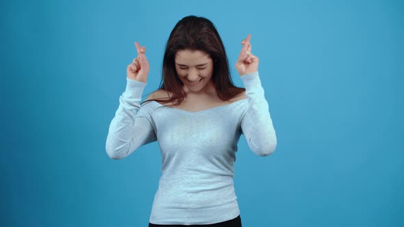 The Beautiful Charismatic Girl Holds Her Fingers Crossed in Both Hands She Hopes That the Wish Will alt