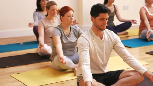 Group of people performing yoga alt