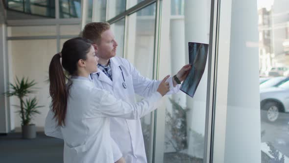 Team of doctors examining x-ray image in the office