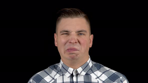 A Young Man Takes Off His Mask and Shows an Emotion of Disgust on His Face. The Man Is Unpleasant. A alt