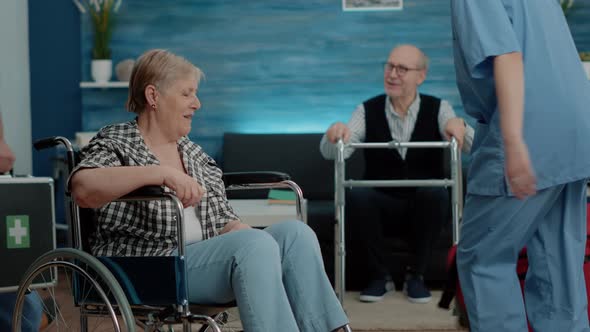 Medical Assistant Giving Support to Senior Woman with Invalidity alt