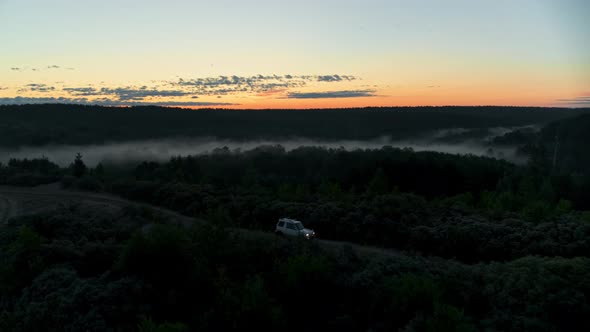 Aerial View of the Car Driving on a Sandy Road