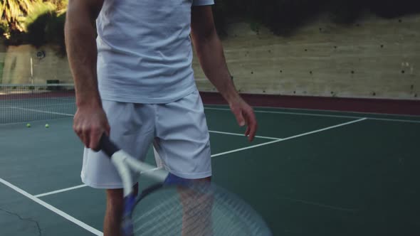 Man playing tennis on a sunny day alt