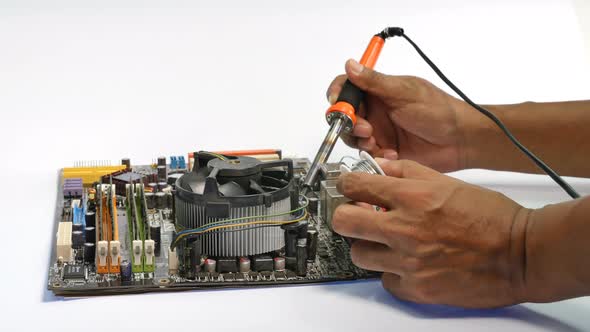 Repair Computer Mainboard By Using A Hand Tool Used In Soldering alt