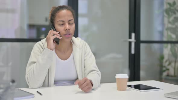 African Woman Talking Angrily on Smartphone alt