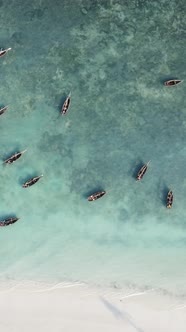 Vertical Video Boats in the Ocean Near the Coast of Zanzibar Tanzania alt