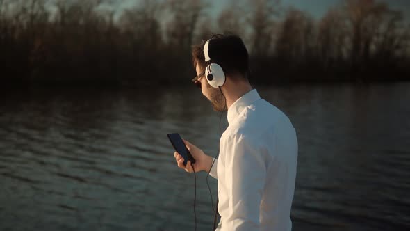 Businessman Relaxing Enjoying After Good News Having Fun Work Break Outdoors. Man Listening To Music alt