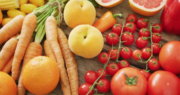 Video of fresh fruit and vegetables over wooden background alt