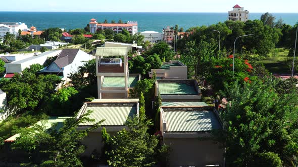 Buildings and resorts in tropical Mui Ne, Vietnam. Ocean horizon in background. alt