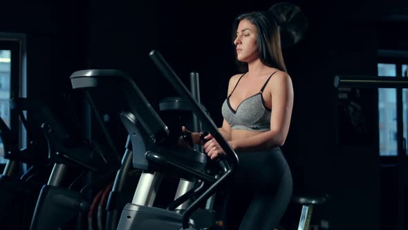 Girl Doing Sports In A Gym. Woman doing exercise at the gym.