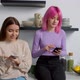 Cute Woman with Birth Anomaly and Girlfriend Networking on Cellphones in Kitchen - VideoHive Item for Sale