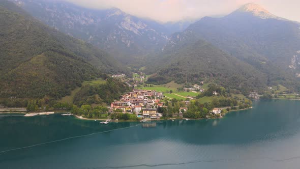 Aerial view of Ledro with lake, Trentino, Val di Ledro in North Italy. Front shot on the water in 4k alt