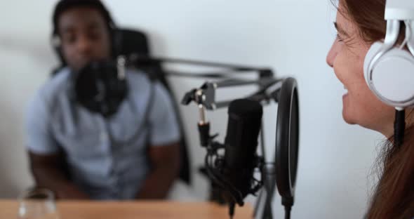 Hosts having podcast session together - Female speaker making an interview during live stream alt