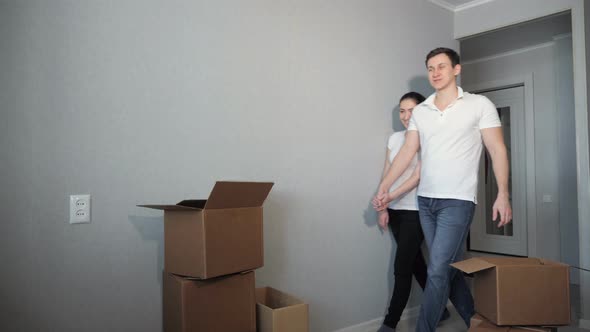 Young Couple Very Happy and Excited About Moving Into New Apartment alt