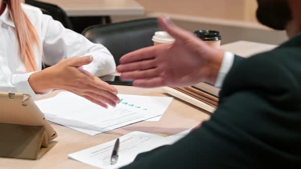 Businessman and businesswoman shaking hands