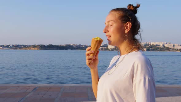 Girl Walks Along Sea Embankment Eats Ice Cream alt