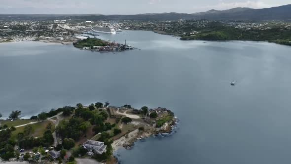 Bird's-eye view of St. John's city, Fort James ruins on a peninsula, marina in Antigua and Barbuda alt