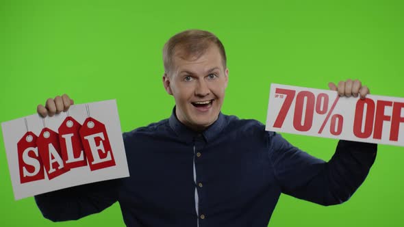 Cheerful Man Showing Sale Word and Showing Up To 70 Percent Off Inscription. Black Friday Concept alt