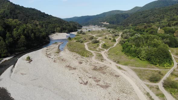 Aerial Flight with Drone DJI Over Beautiful Green Mountains and River