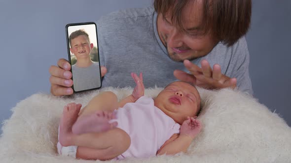 Happy Family Having Video Father with Children Waving Chatting To Friends on Mobile Phone Enjoying alt