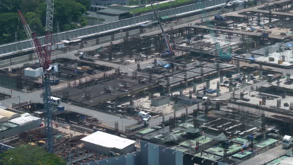 Large construction site with heavy construction machinery in metropolis alt