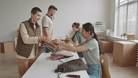 Volunteers Giving Clothes and Food to Needy People alt