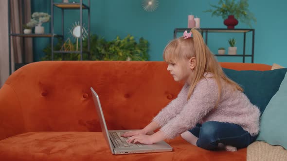 Joyful School Kid Girl Use Laptop Computer Learning Reading Online Education Lessons Alone at Home alt