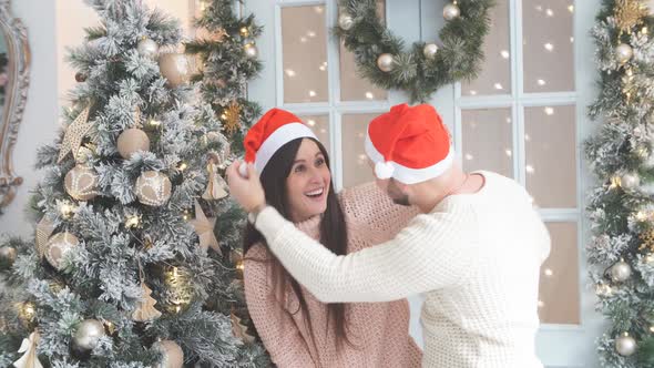 Young Couple Having Fun Near the Christmas Tree