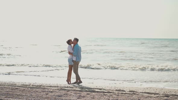 Romantic Couple Embracing Holding Hands and Smiling to Each Other alt